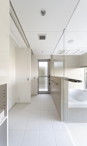 ガラス張りの浴室がより広さを感じさせる、ホテルのような洗面所