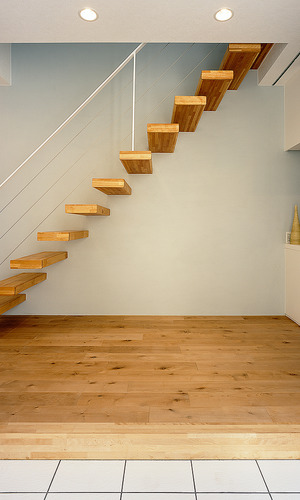 フローリングと雰囲気を合わせ、壁から生えたかのようにスッとのびる美しい階段
