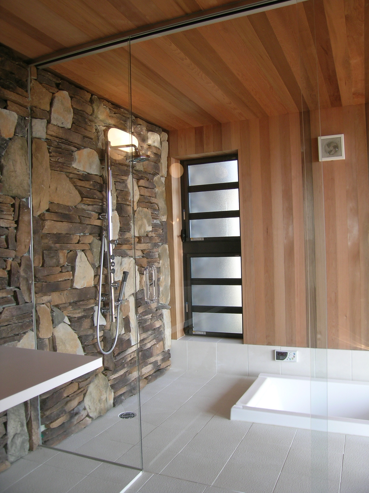 石張りと木素材で自然のぬくもりが感じられるバスルーム