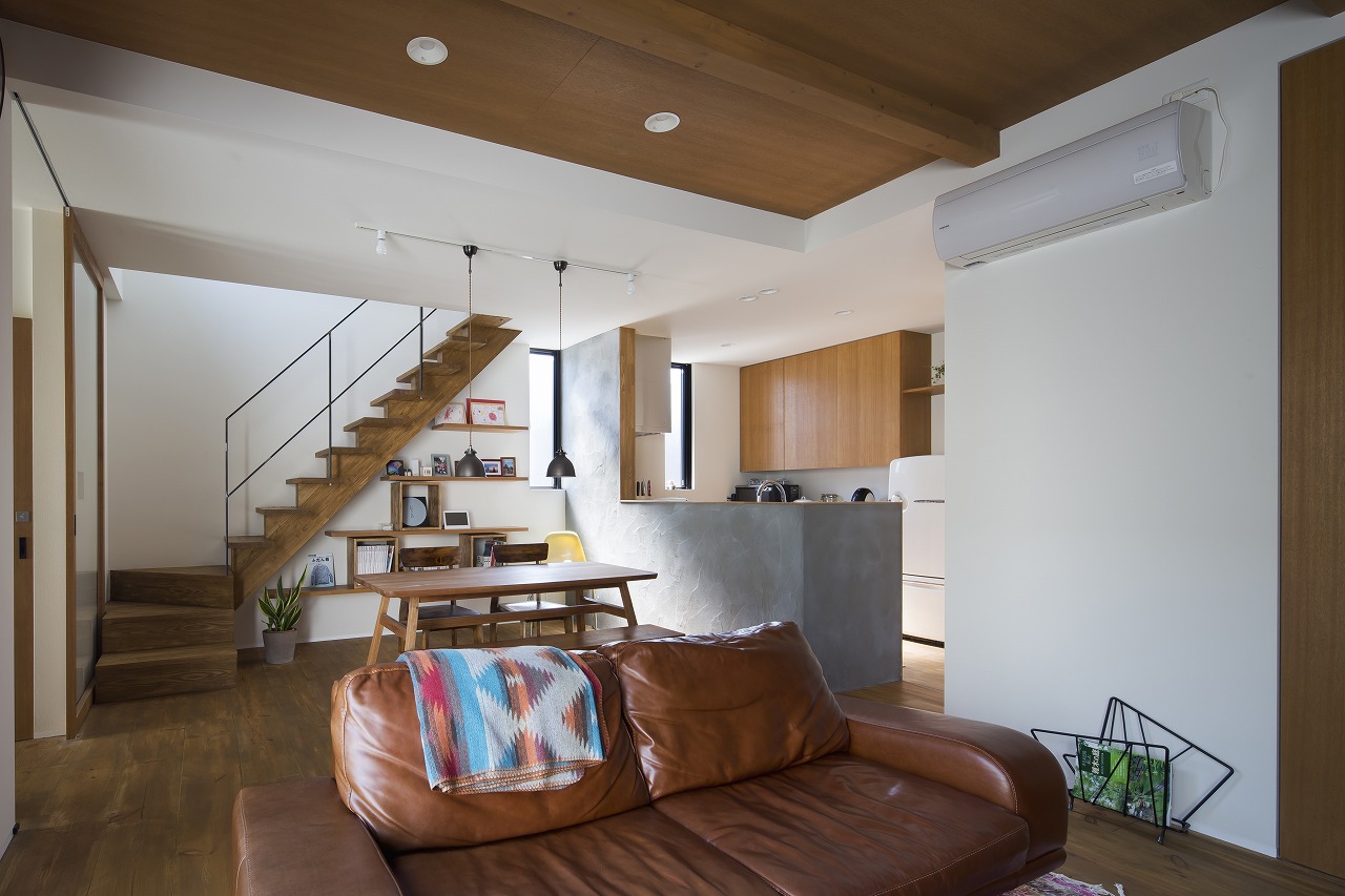 味のある幅広の床材が階段周りや家具と統一感があるリビング