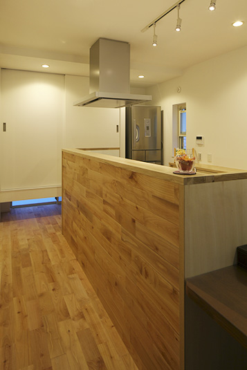 木の板を貼る事で部屋と一体となったキッチン