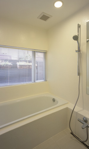 大きめの窓から、月光浴を楽しめる真っ白な在来浴室